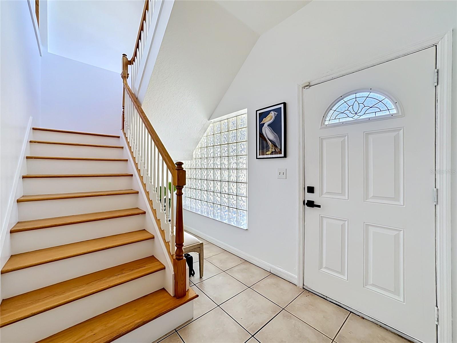 Grand entry with staircase leading to main living level upstairs