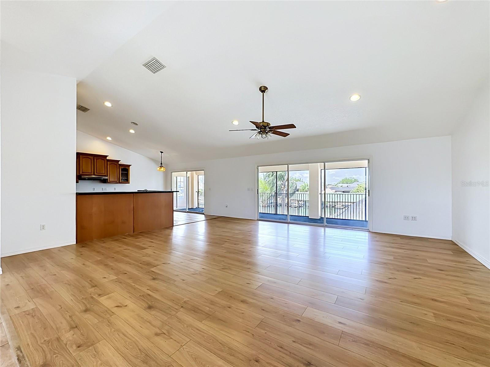 Open-concept living flowing into the kitchen with views beyond