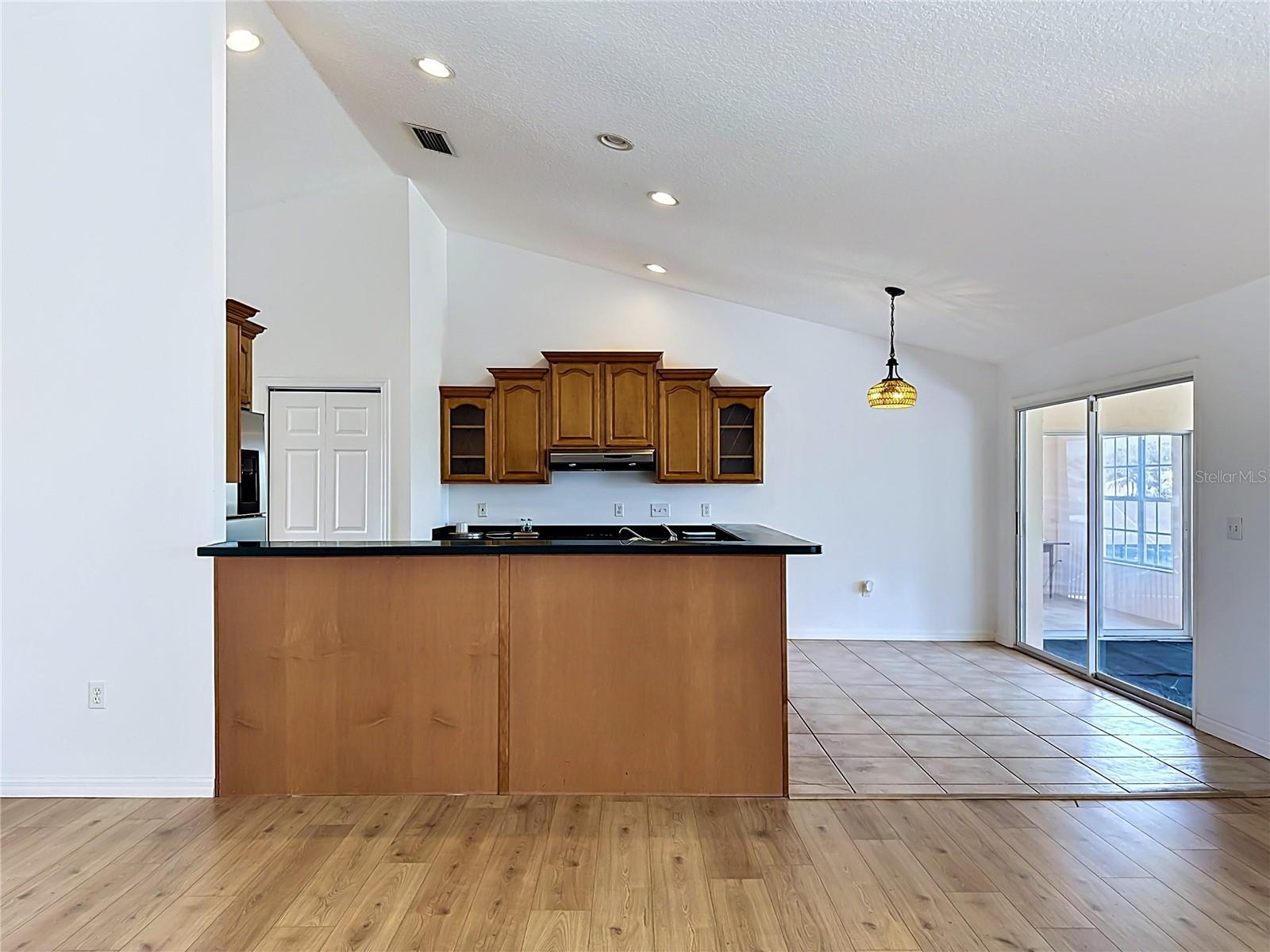 Solid wood cabinetry and stone counters in chef's kitchen