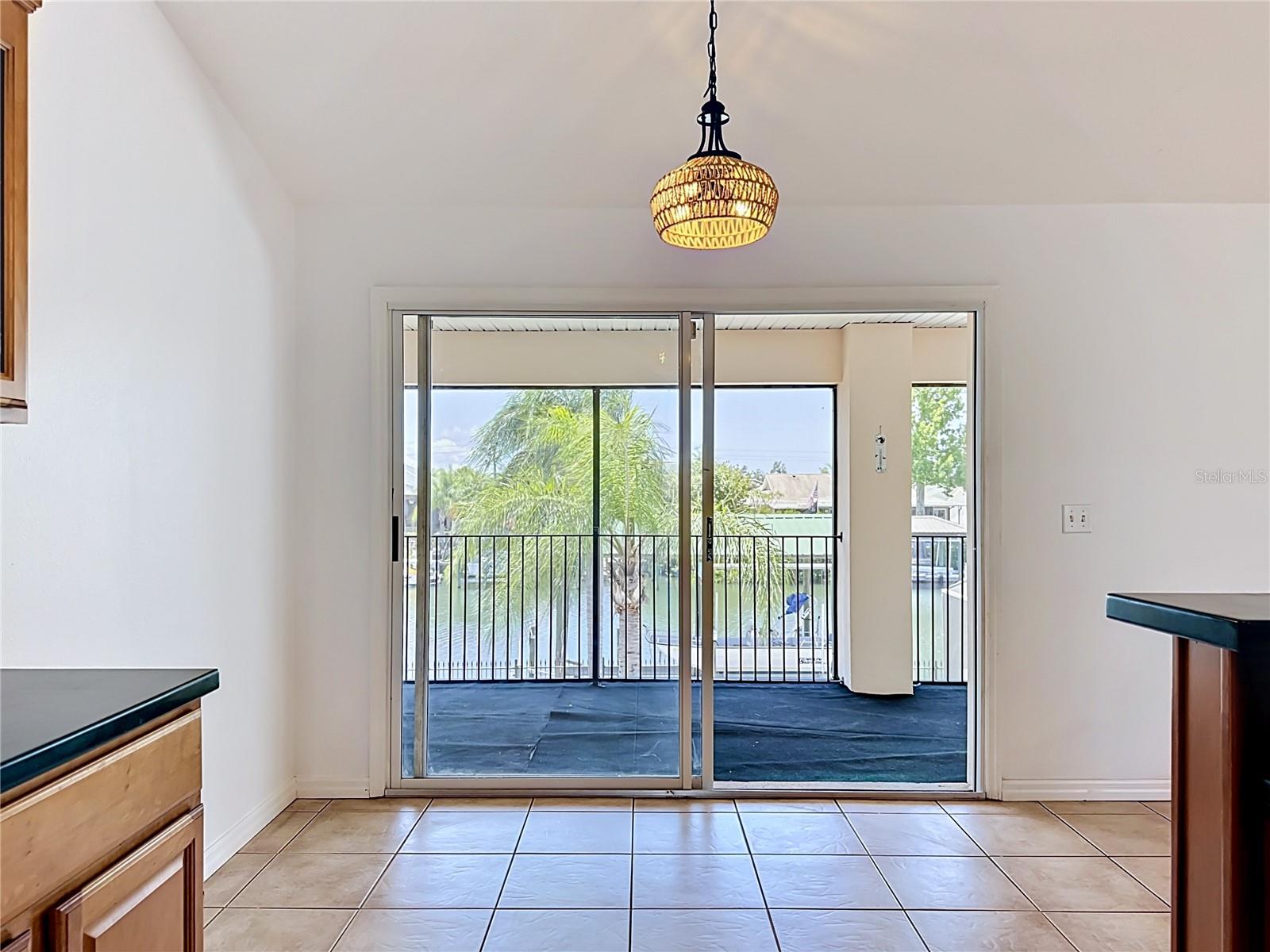 Sliding doors in breakfast nook leading to the screened balcony