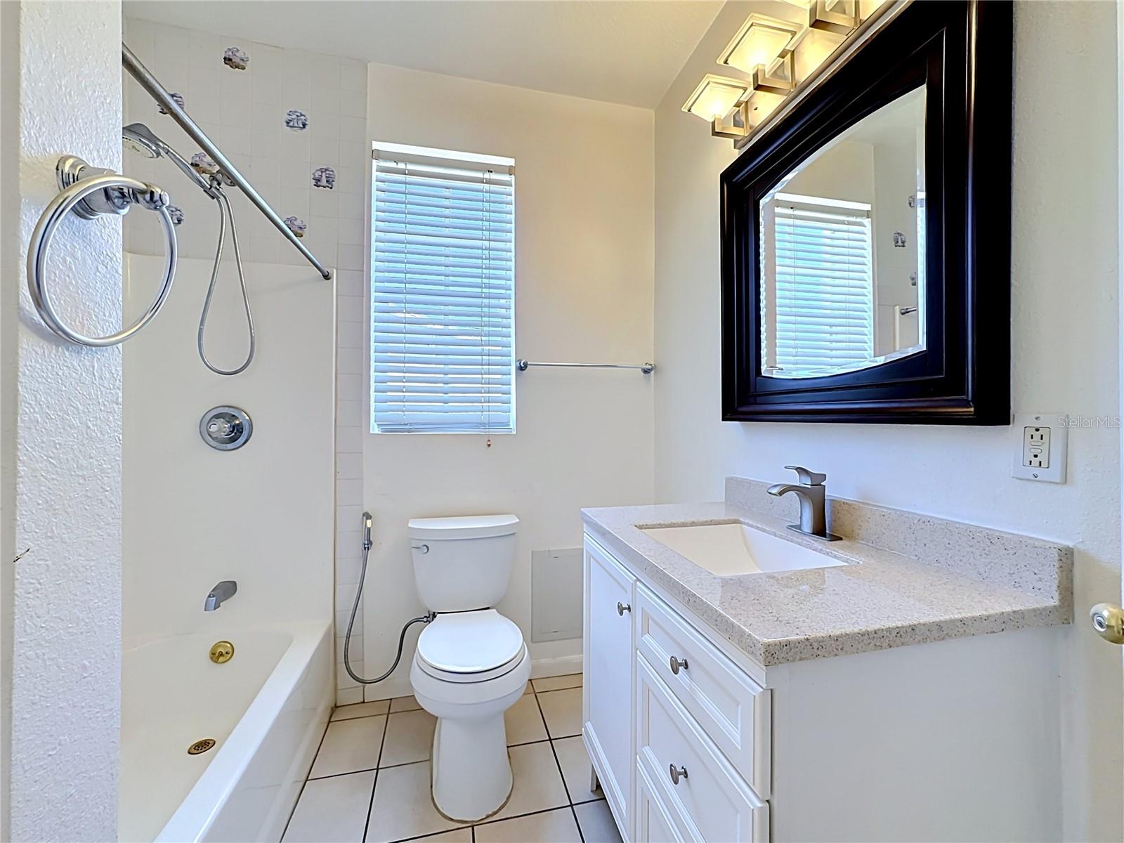 Downstairs Updated guest bath with stone-top vanity