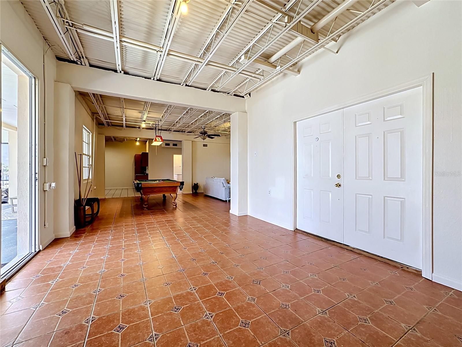 Downstairs hallway leading to 2 car side garage