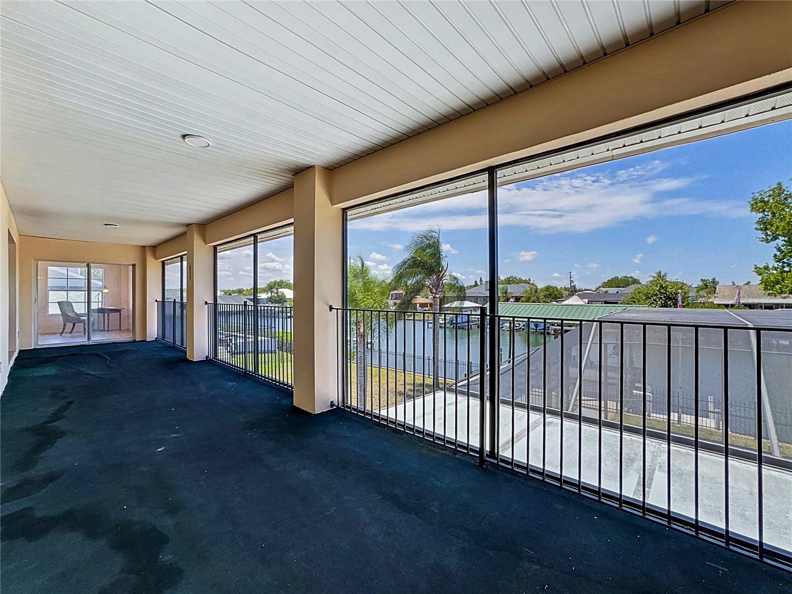 Relax on the screened balcony overlooking the canal