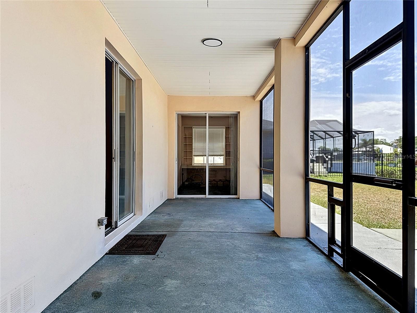 Screened balcony entry with canal views beyond