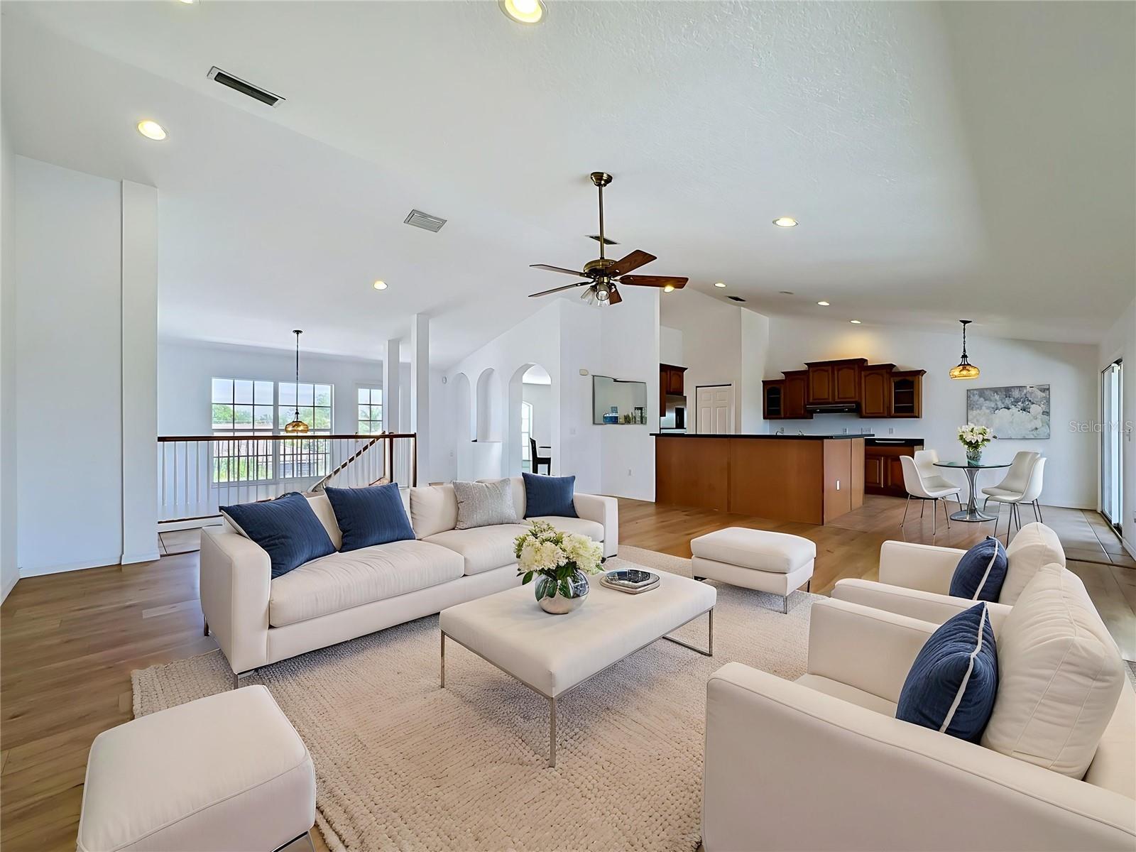 Open-concept main living level — kitchen, living, water views
