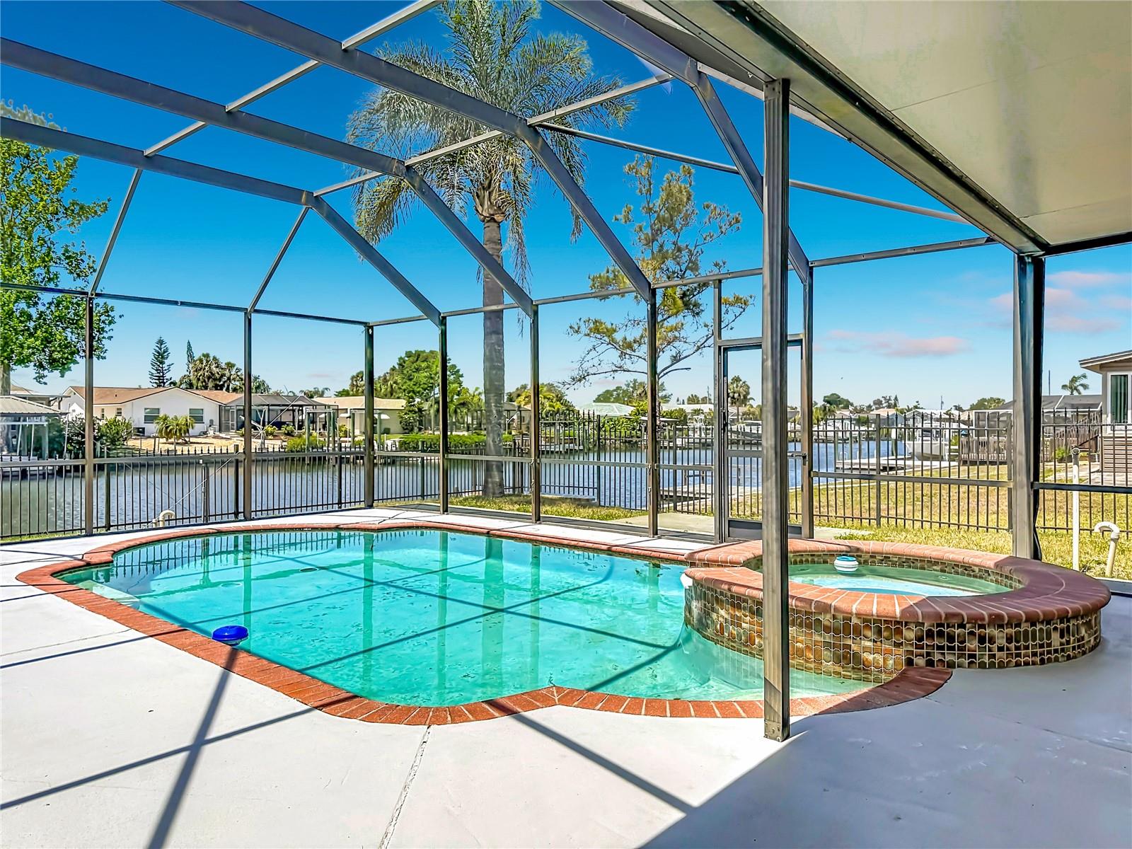 Pool overlooks the deep water canal — ultimate waterfront living