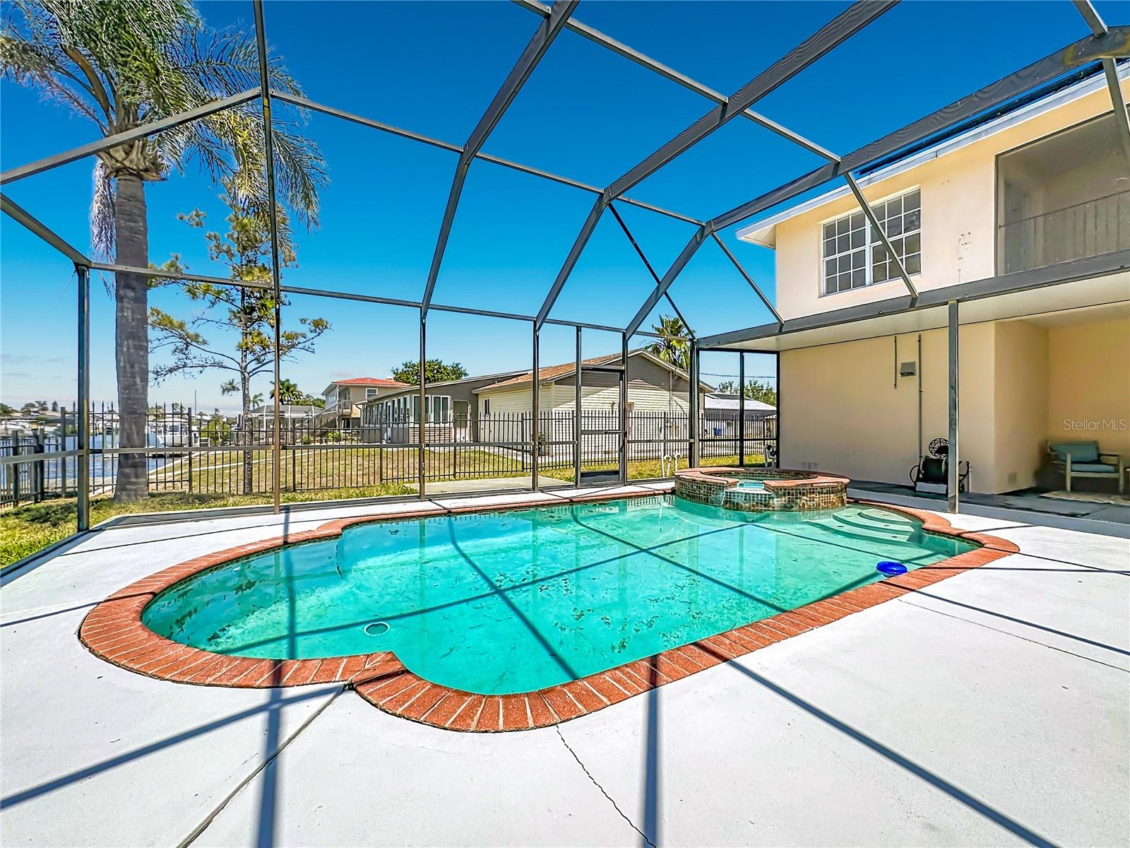 Pool, lanai, and home from the canal-side perspective