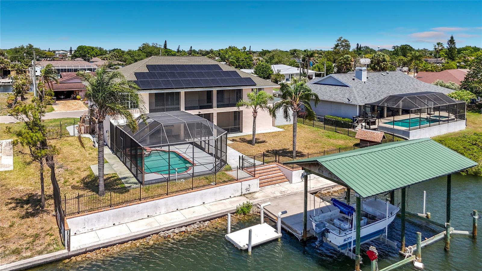 Pool, dock, and canal frontage from above