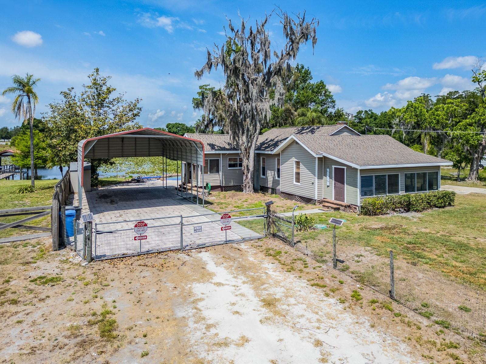 Front exterior of home with driveway and carport
