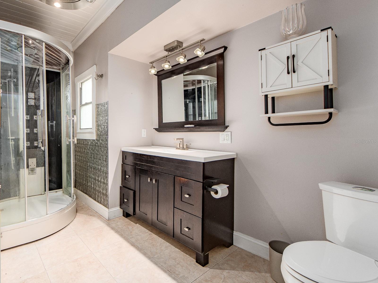 Bathroom with vanity and storage