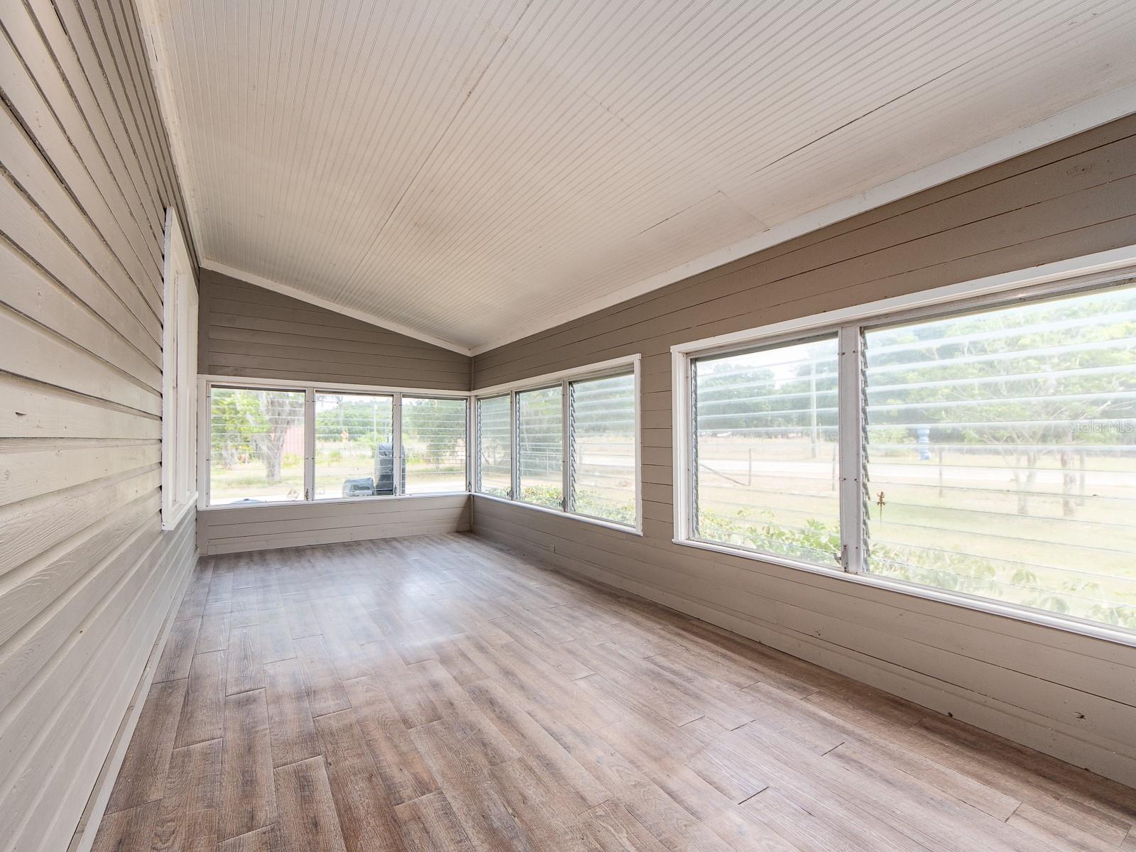 Bright Florida room with large windows