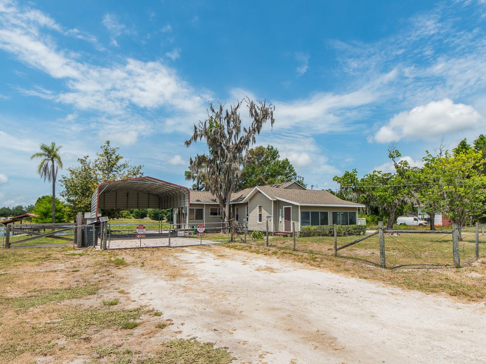 Front exterior of home with driveway and carport