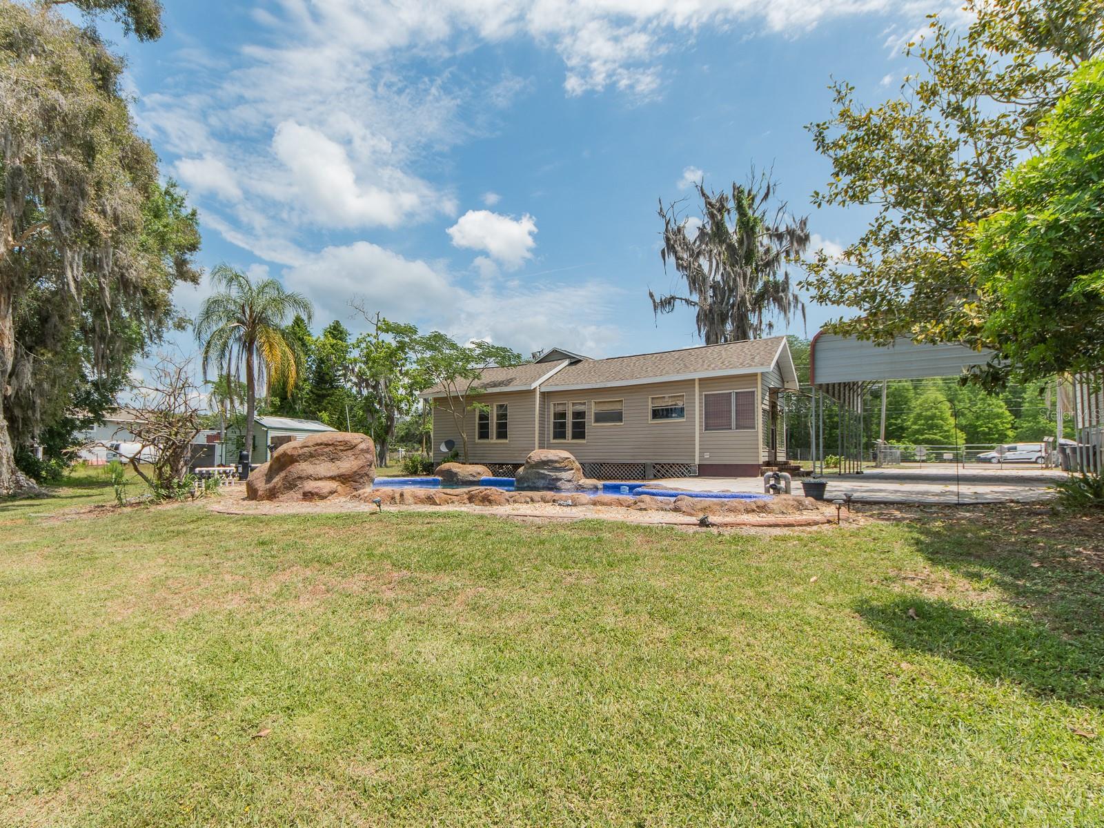 Rear view of home and yard