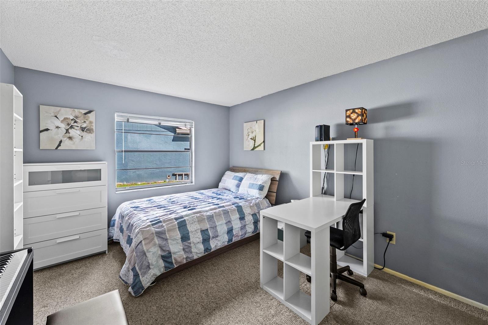 Secondary bedroom with space for sleeping, studying, or guests.