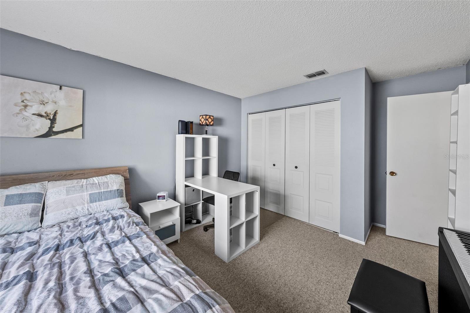 Secondary bedroom with closet storage and flexible layout.