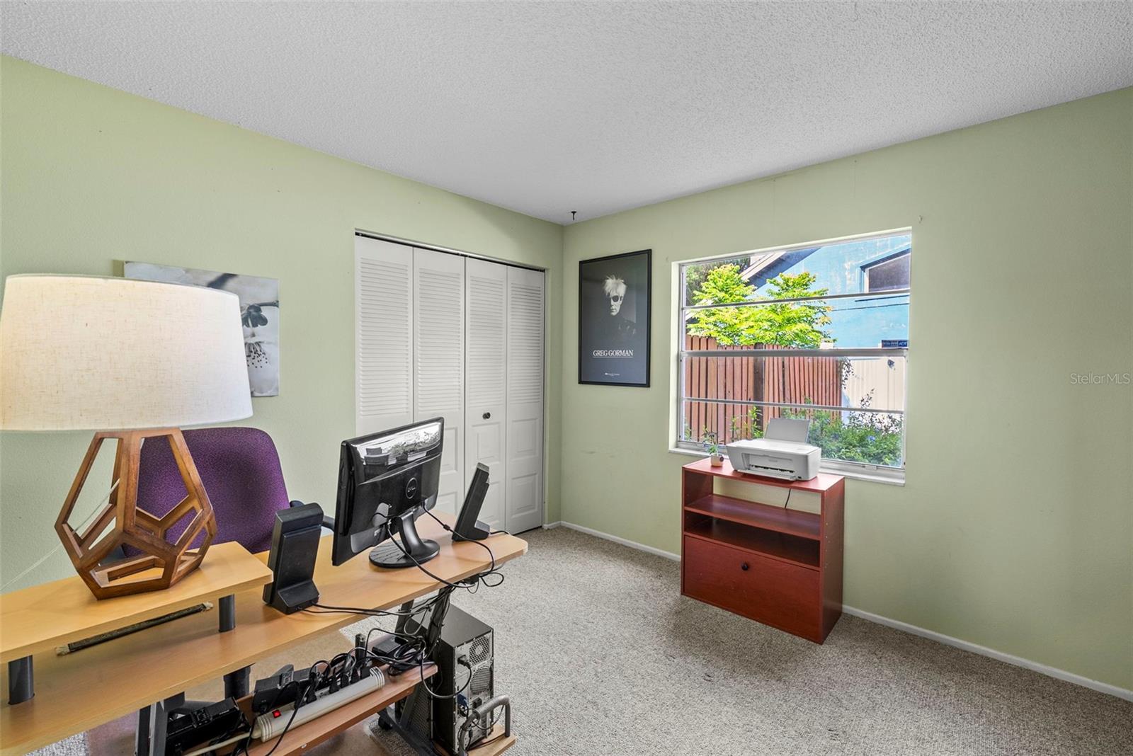 Third bedroom or home office with backyard-facing window.