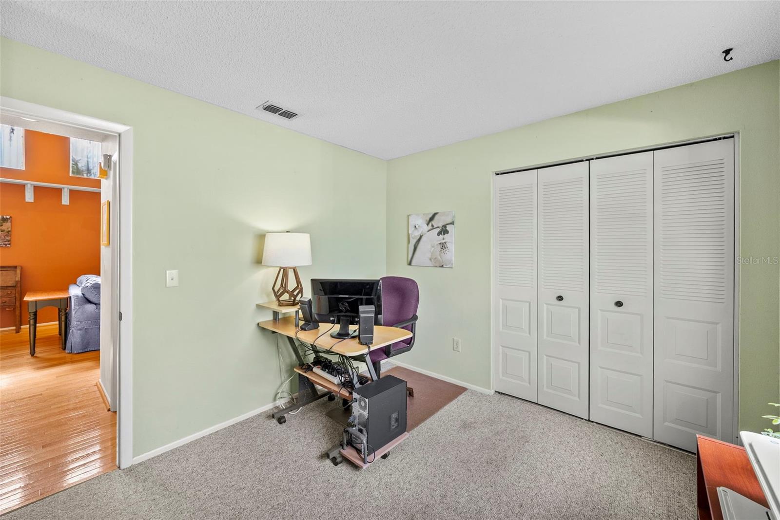 Flexible bedroom/office space with closet and natural light.