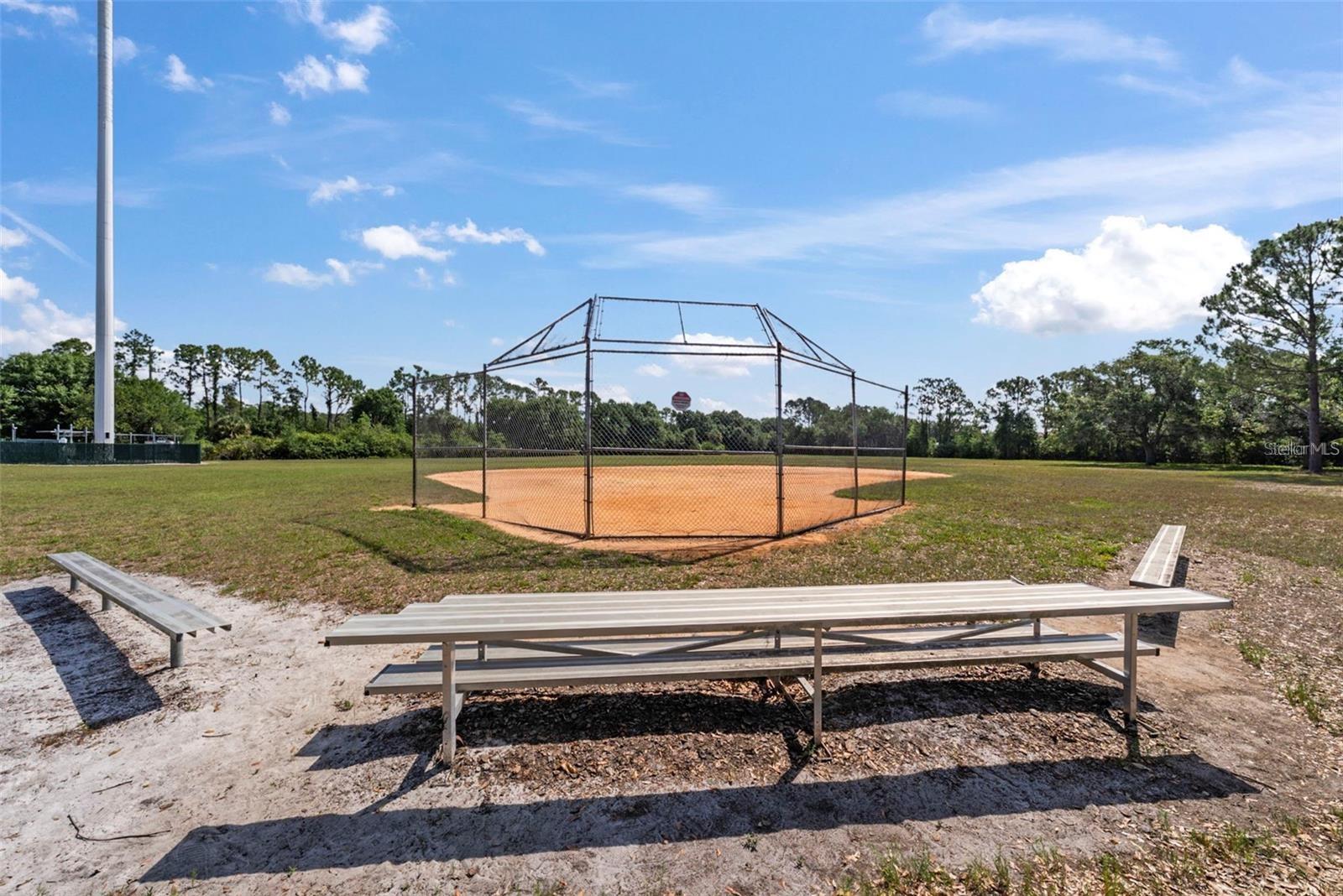 Community baseball field with seating and open space.