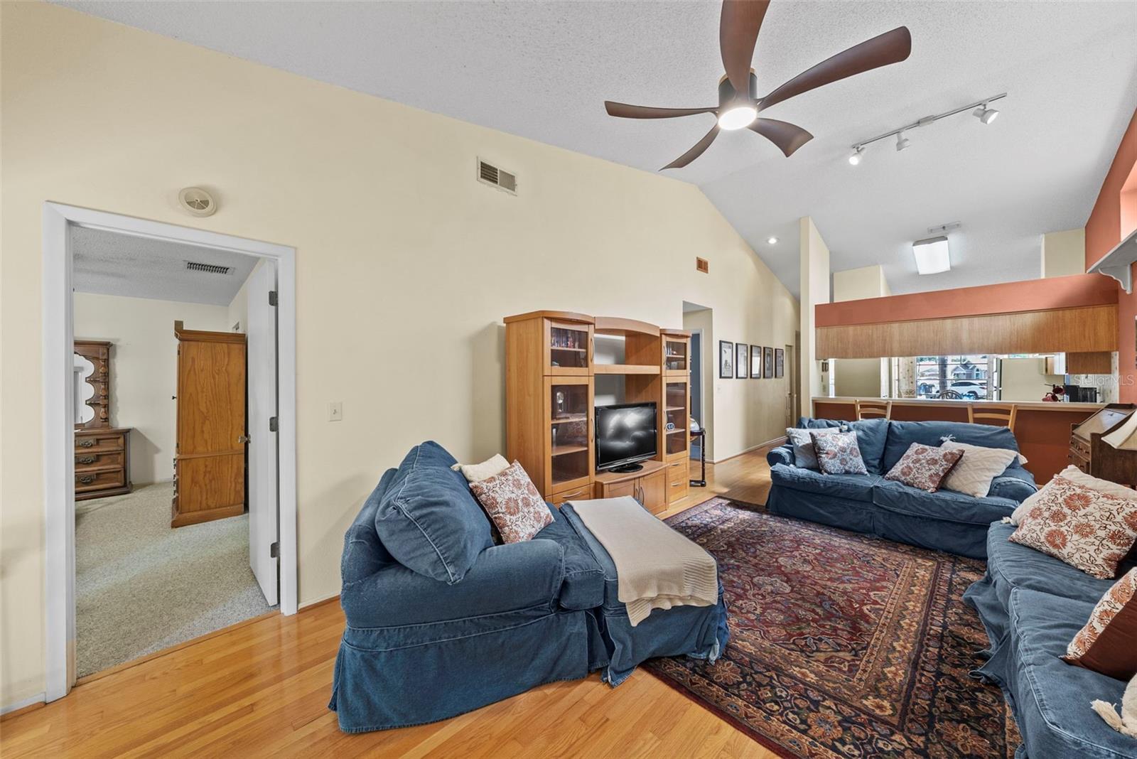 Open-concept living area with vaulted ceilings and easy kitchen connection.