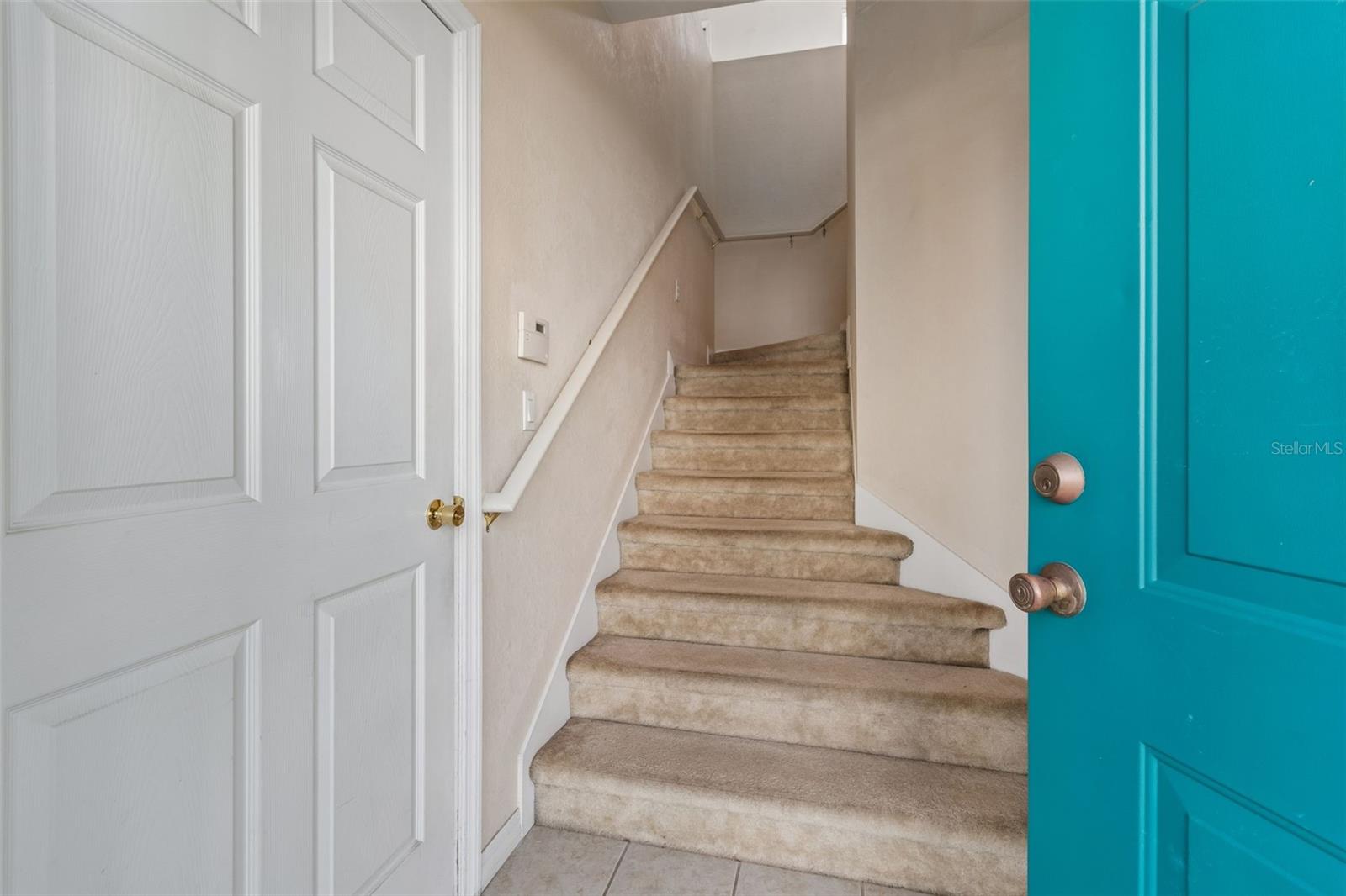 stairs to the living area of the home & garage door access