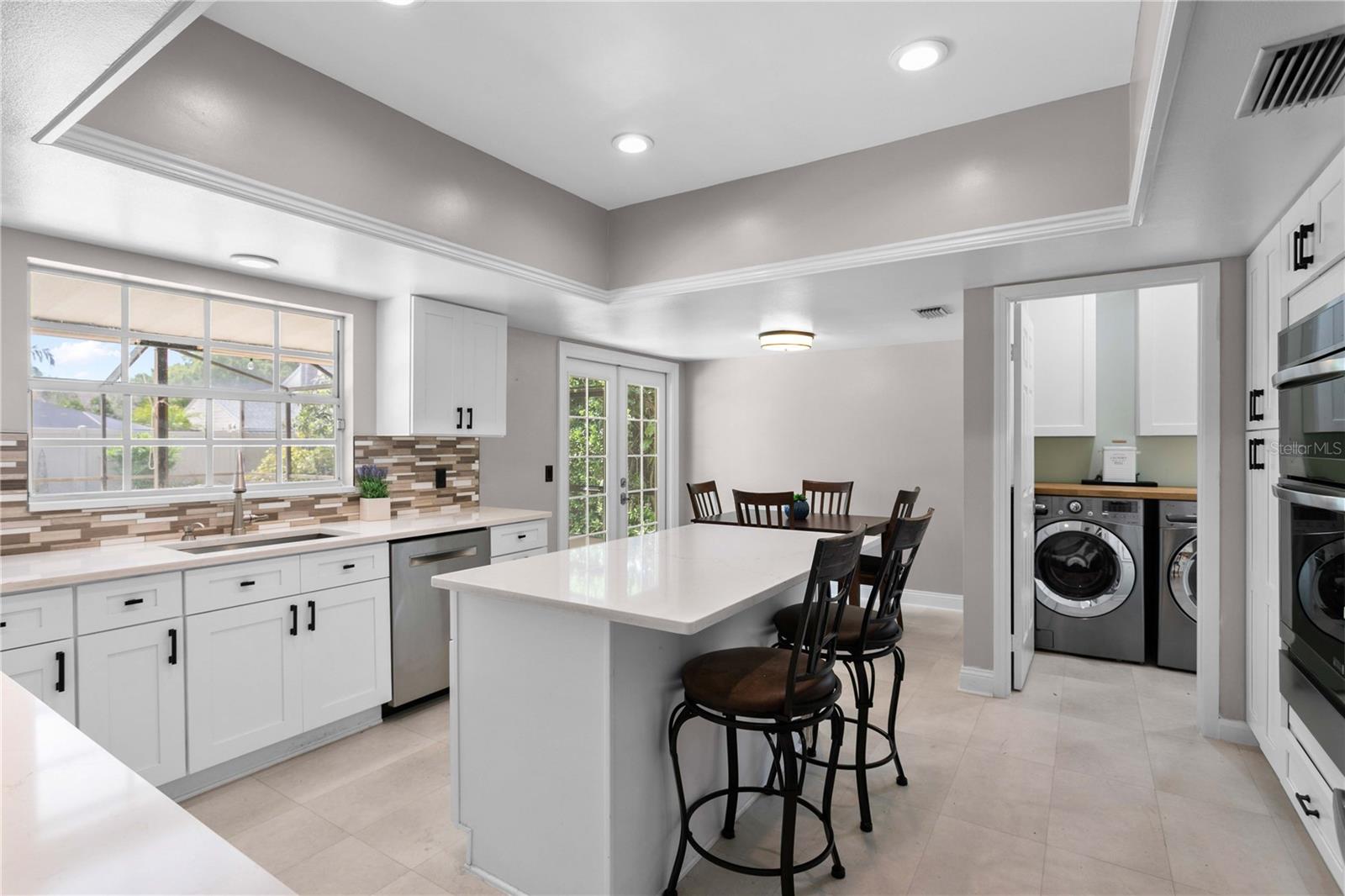 Kitchen remodeled in 2025 with quartz counters and glass tile backsplash