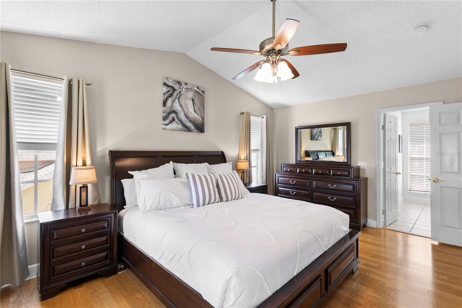 Primary suite features vaulted ceiling and en suite primary bath