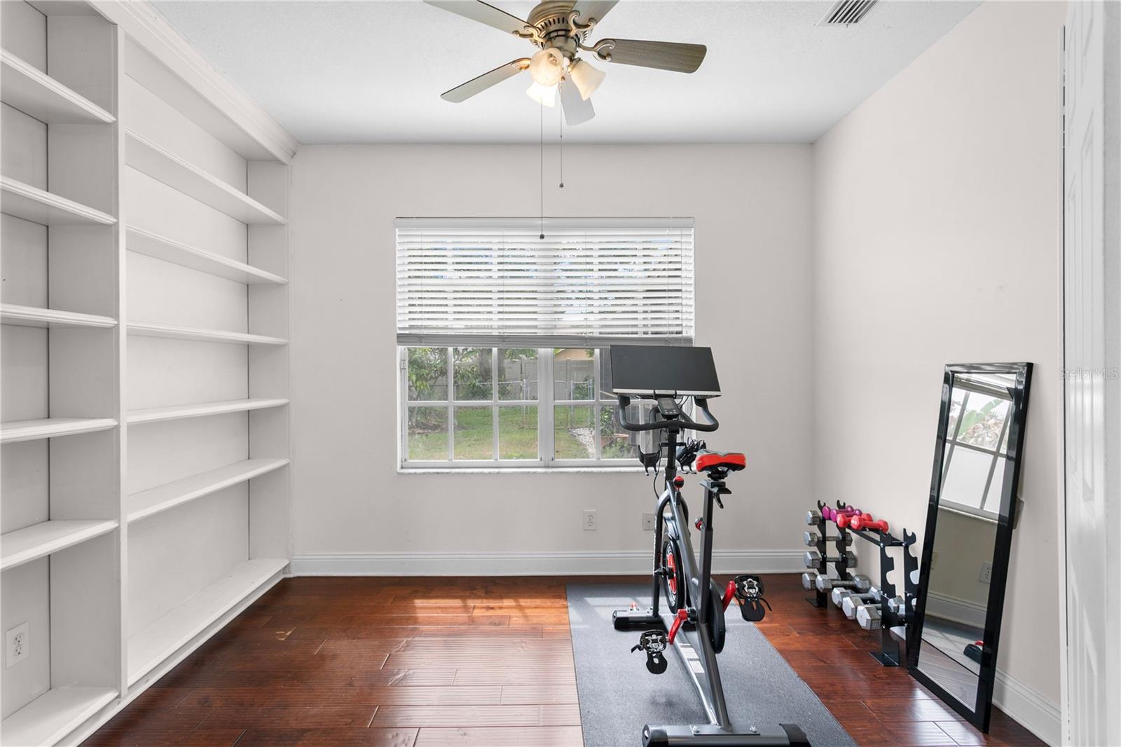 First floor home gym or office with built-in shelving unit
