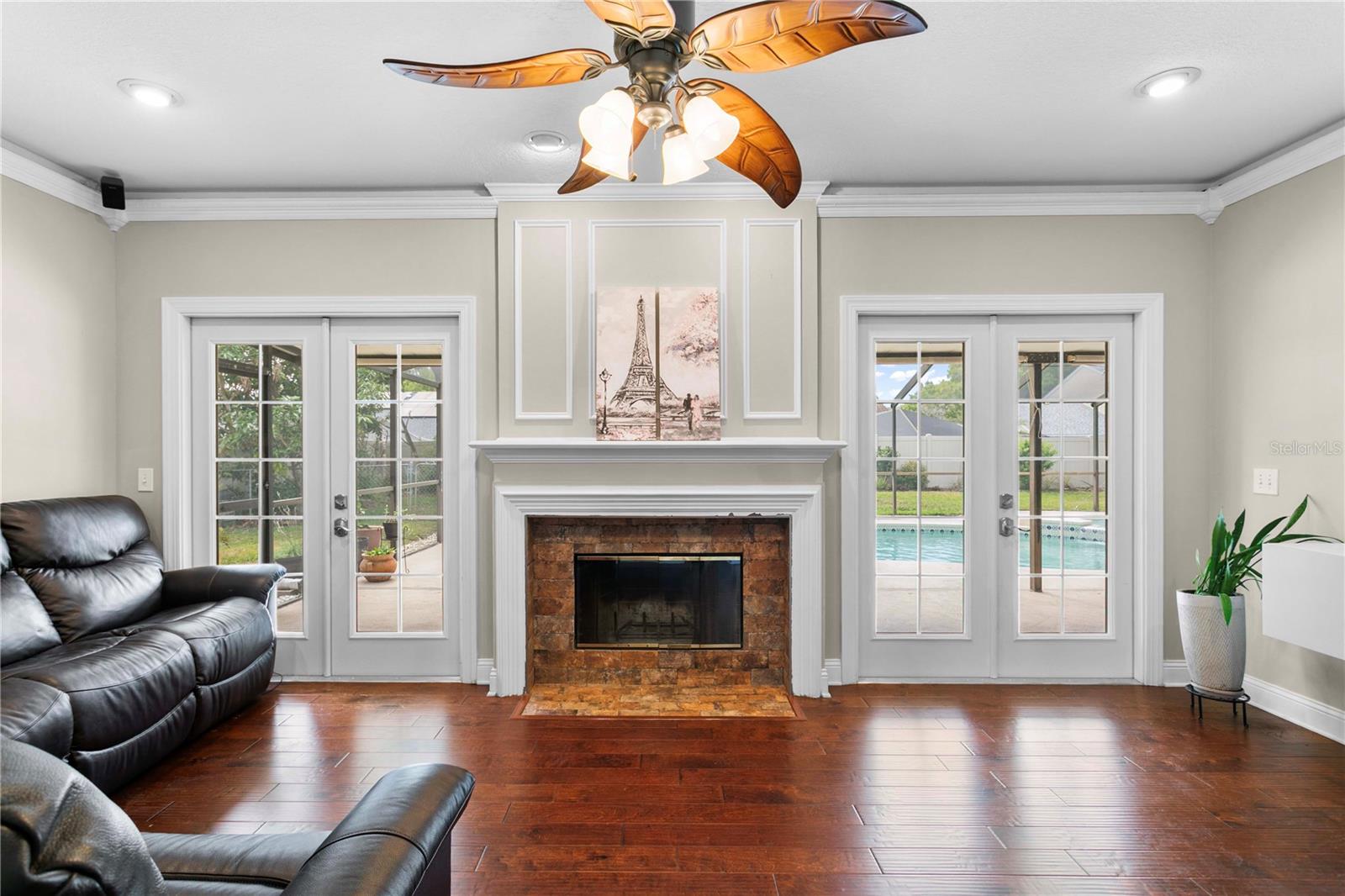 Family room features two french doors leading to the screened in pool and lanai