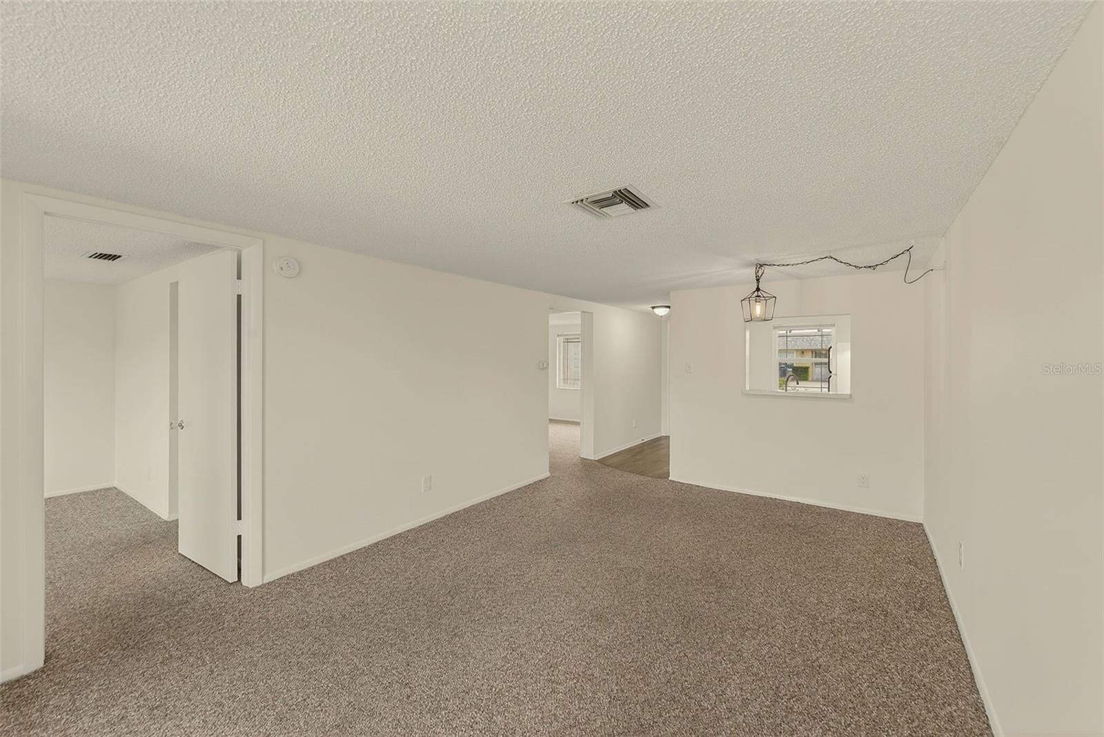View of living/dining room with view of bedrooms