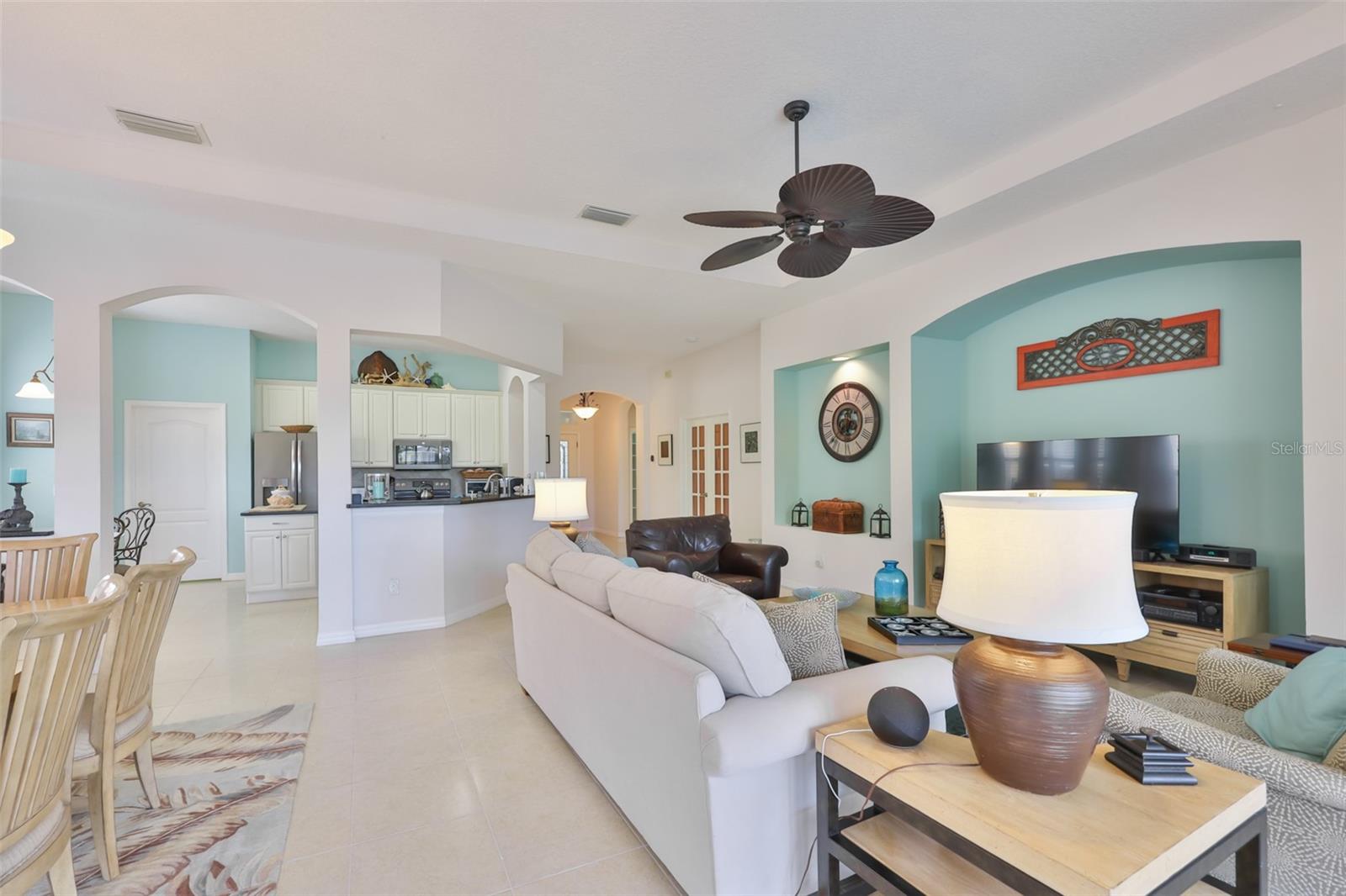 Notice the open feeling, trey ceiling and arched doorways that accent the home.