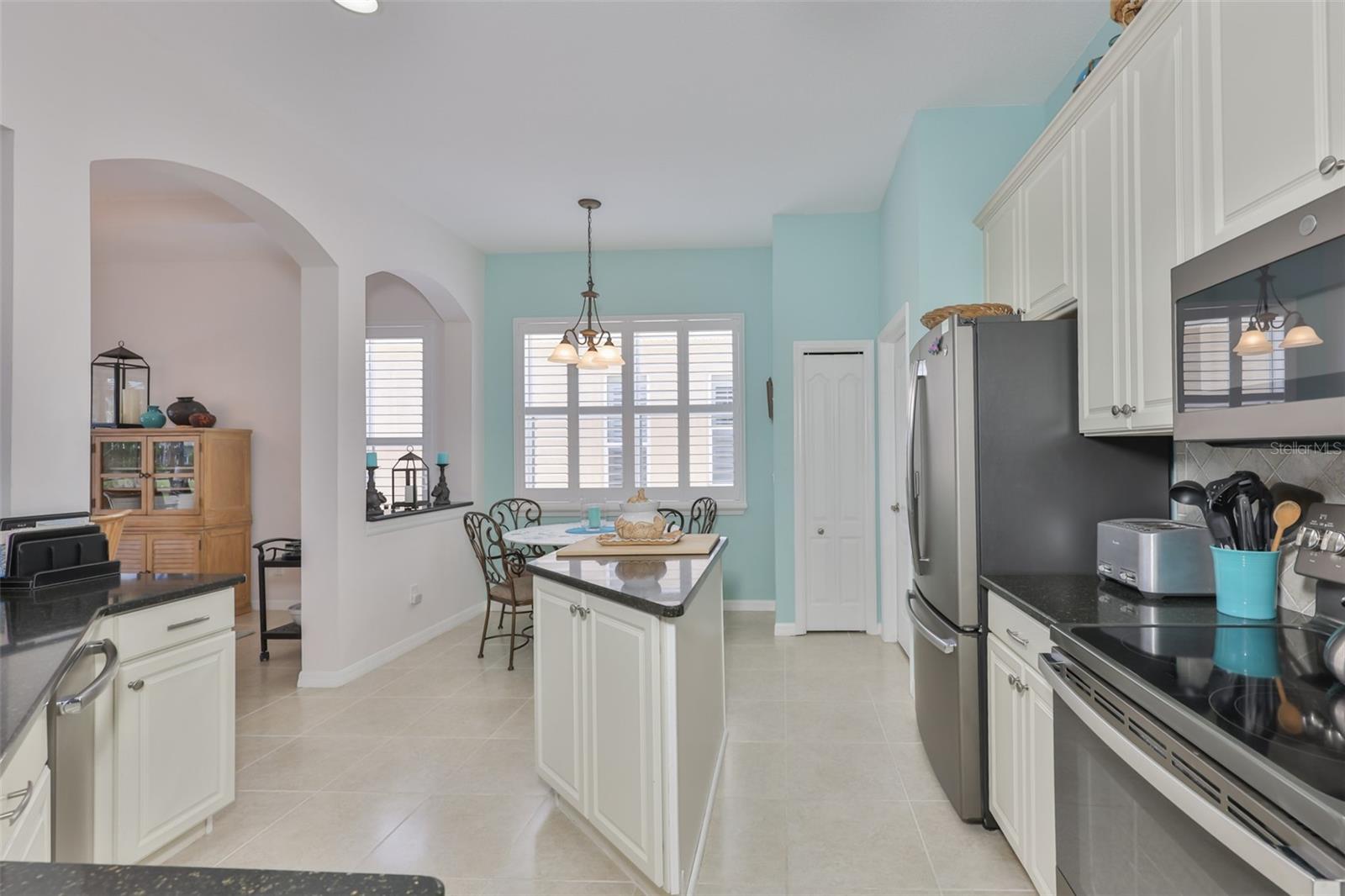 Granite Counters, Island, Stainless Steel appliances, closet Pantry and large windows for lots of natural Florida sunshine.