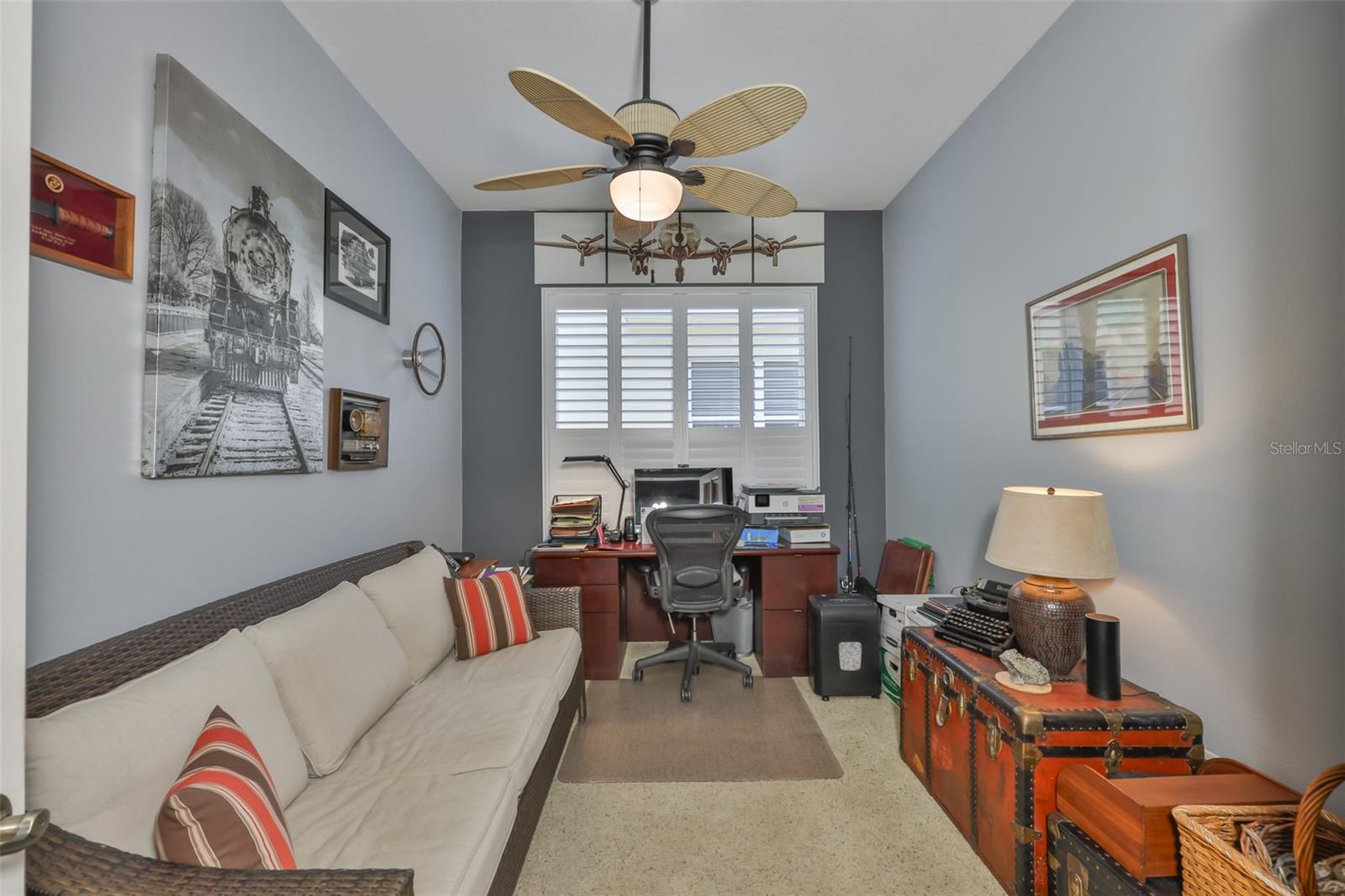 Bedroom #2 has a large window with plantation shutters.