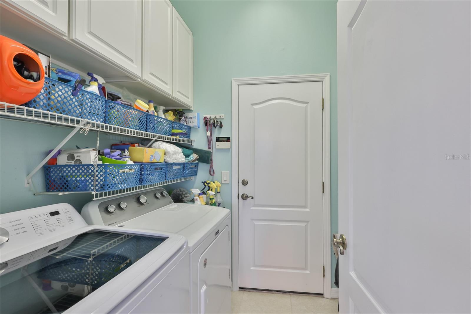 Laundry room is inside with cabinets and shelvings