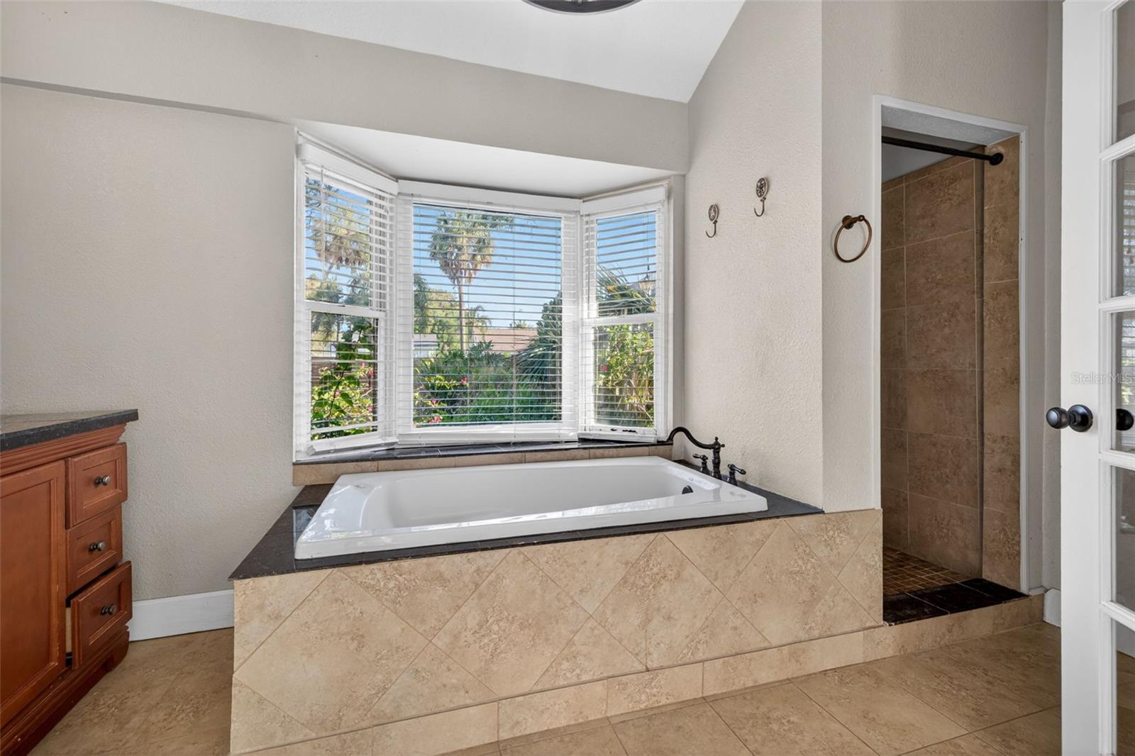 Oversized soaking tub for relaxation and rejuvenation.