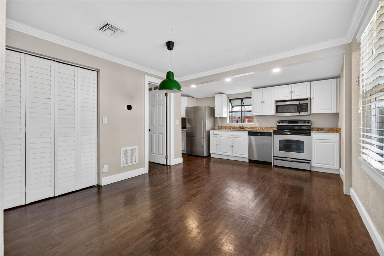 Modern meets classic with crisp white cabinetry, granite countertops, and stainless steel appliances.