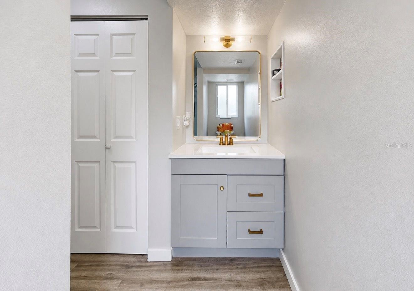 Primary suite bathroom and walk in closet.