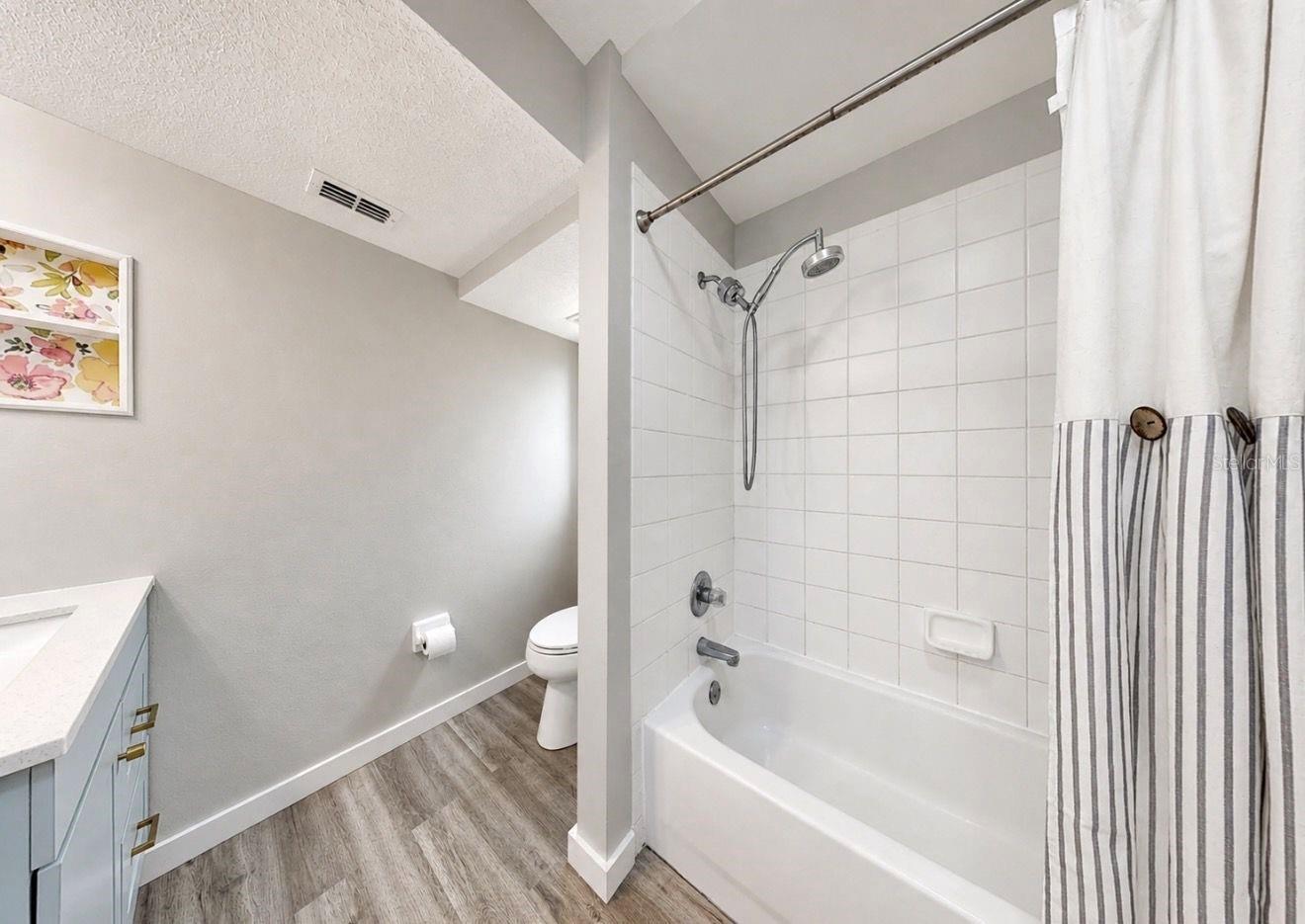 Primary suite bathroom and walk in closet.