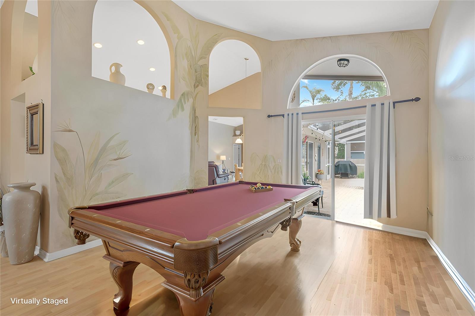 The living area showcases unique arched architectural cutouts that add character and custom charm throughout the space.