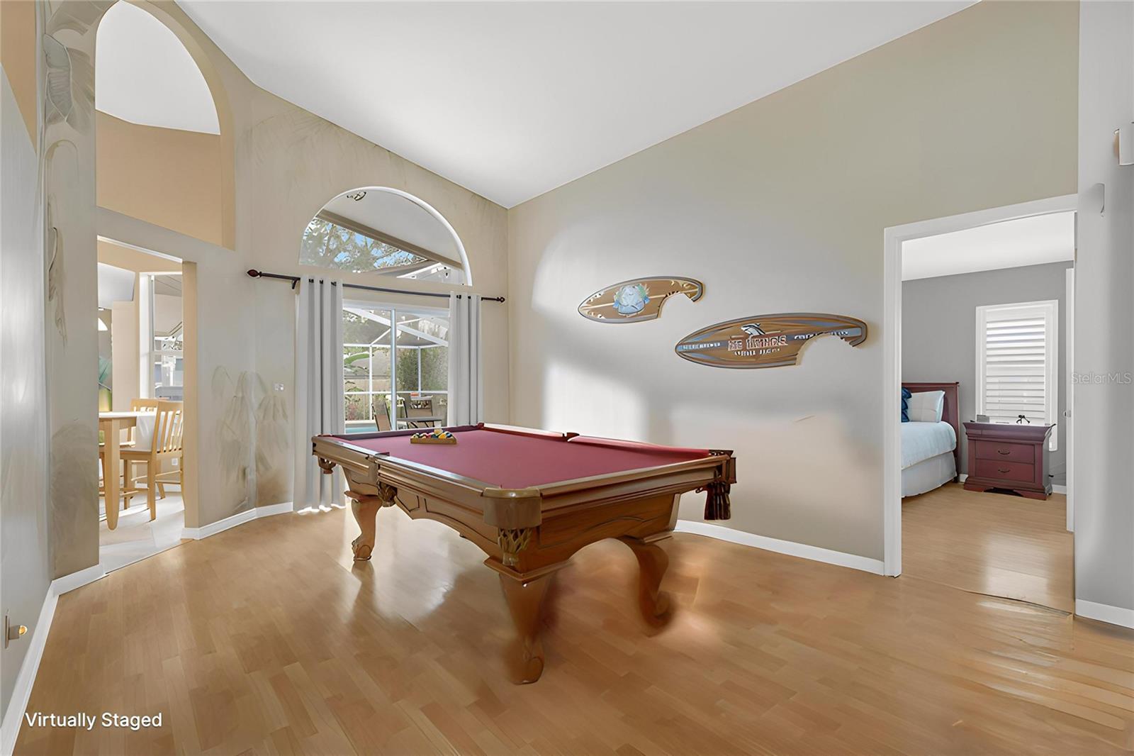 The living area features sliding glass doors topped with an elegant arched transom window that fills the space with natural light.