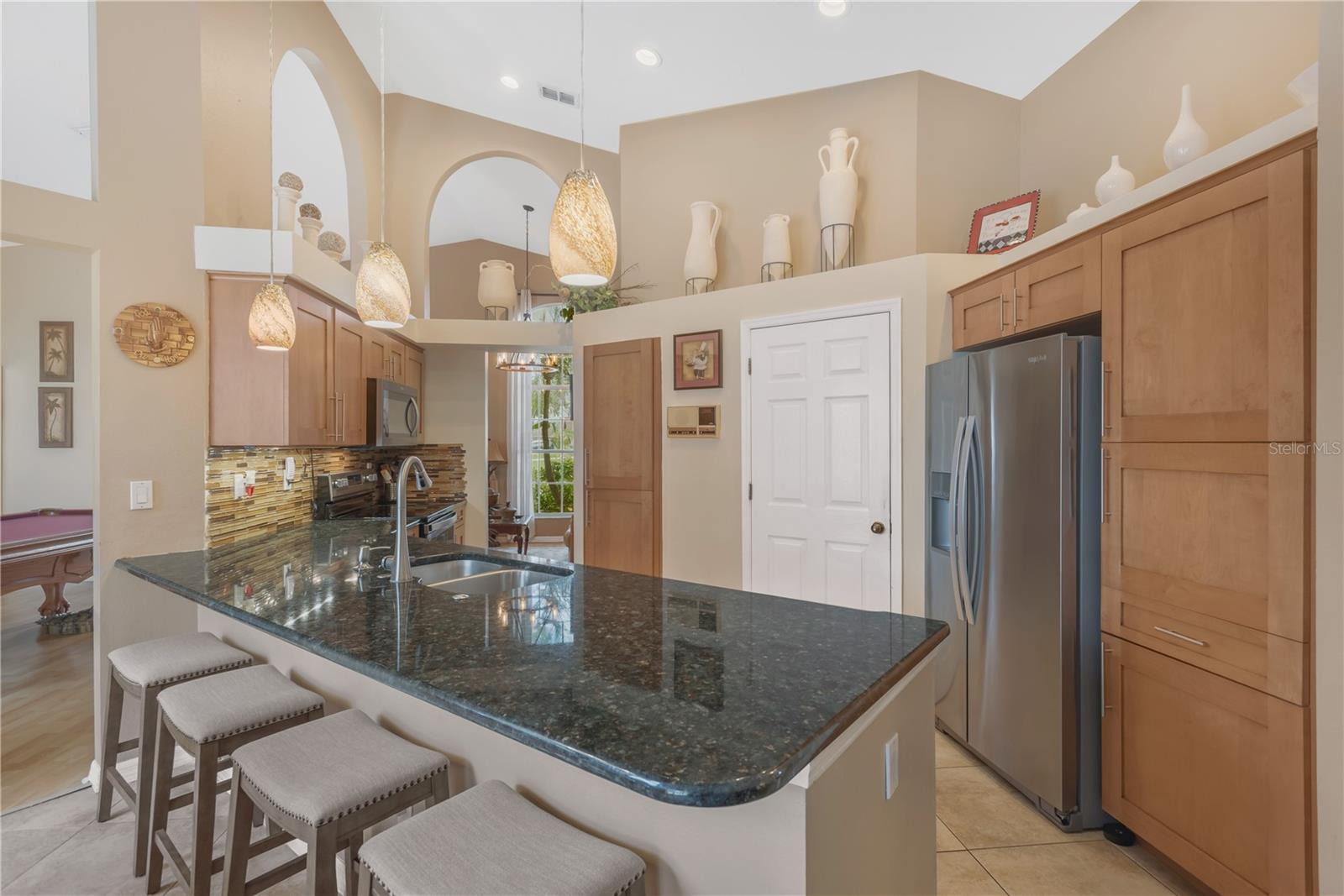 Wide sliding glass doors create a seamless transition for effortless indoor-outdoor entertaining.