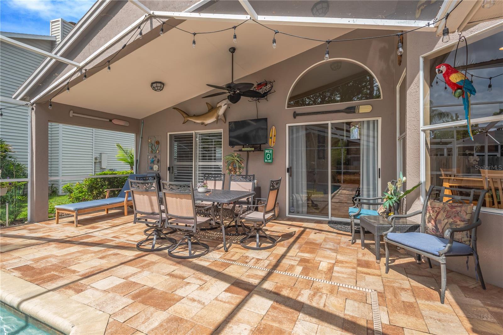 A spacious covered lanai provides the perfect setting for outdoor entertaining, even during Florida’s summer rain showers.