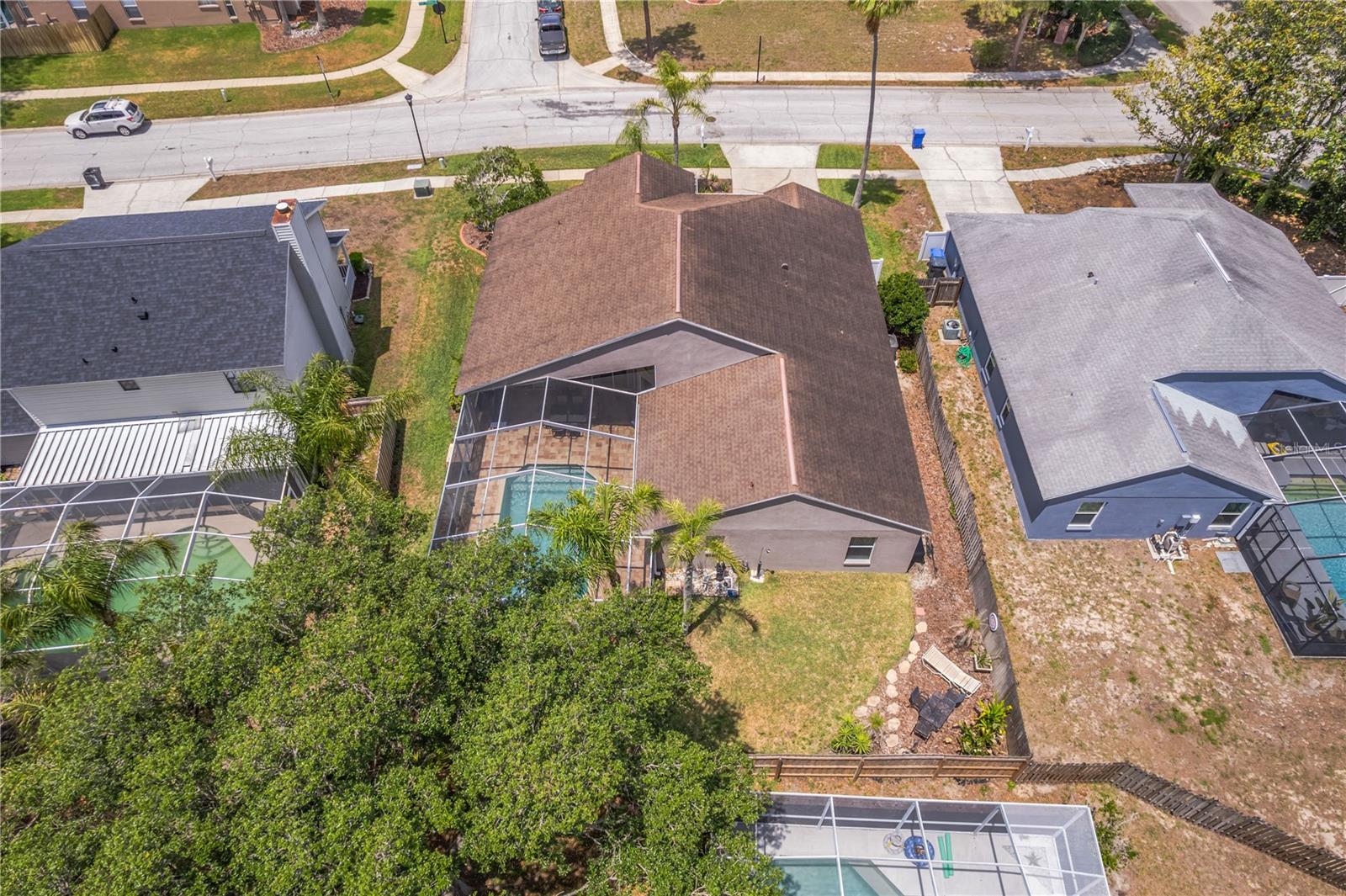 The backyard features partial wood fencing and could easily be fully enclosed with minimal effort, creating the perfect space for pets to roam safely.