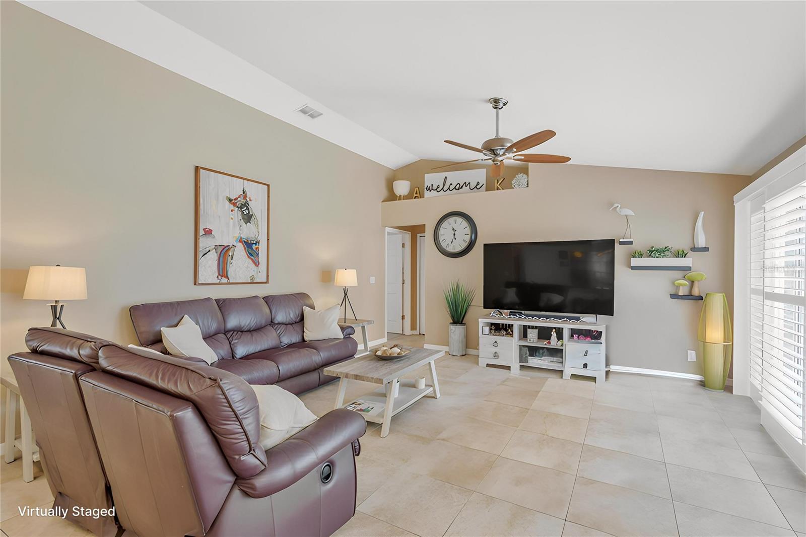 The family room showcases soaring cathedral ceilings and offers the perfect space for relaxing, entertaining, and gathering with family and friends.