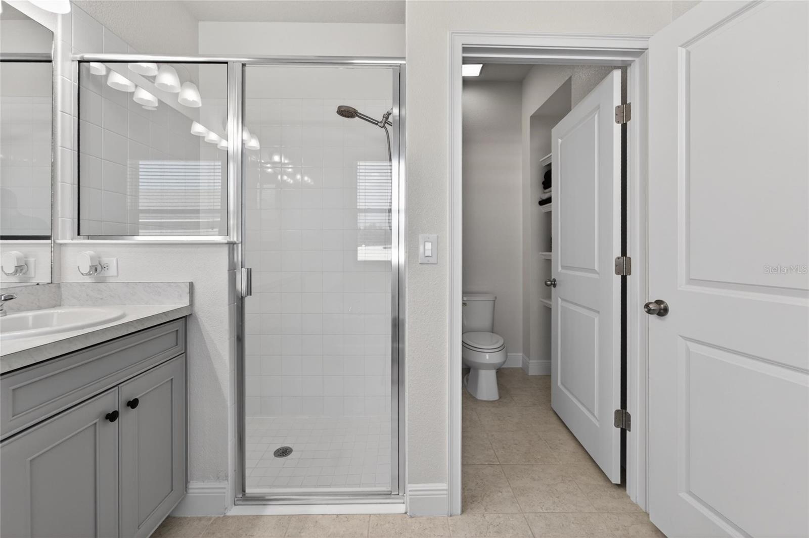 Relax and recharge in the spacious primary bathroom.