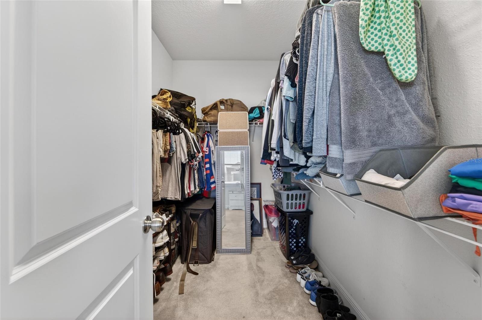 Large owner’s suite closet with room for everything.