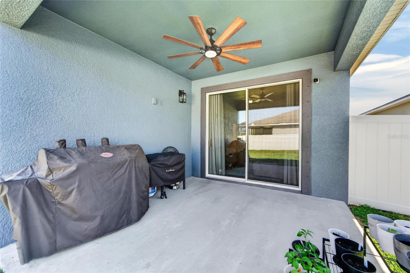 Covered lanai overlooks a generously sized private backyard.