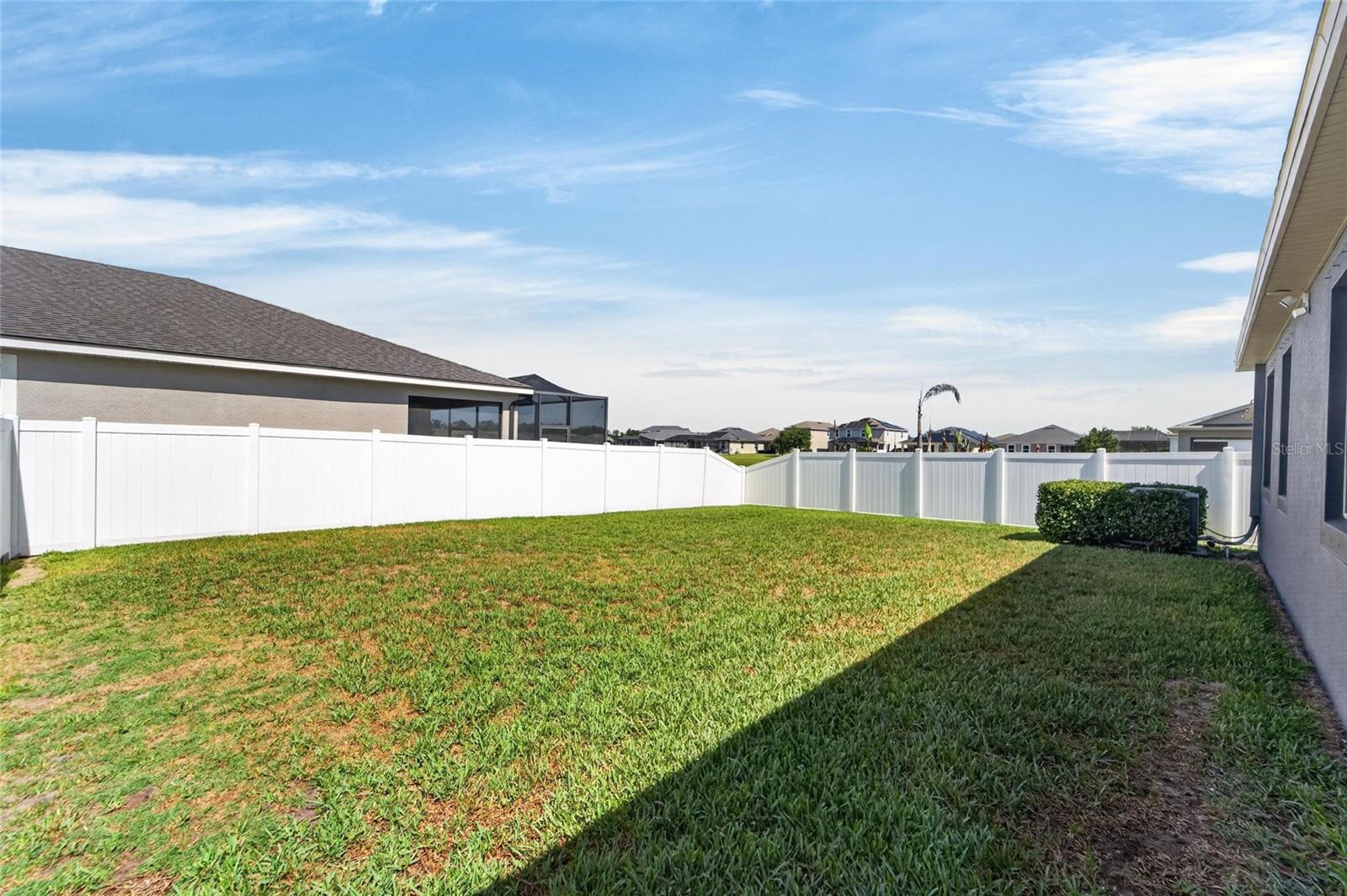 Large backyard with privacy fence provides room to spread out and enjoy.