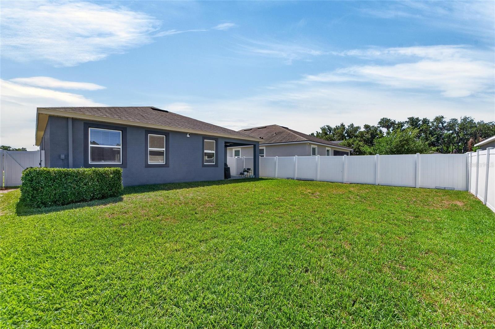 Fully fenced backyard offers added privacy and functionality.