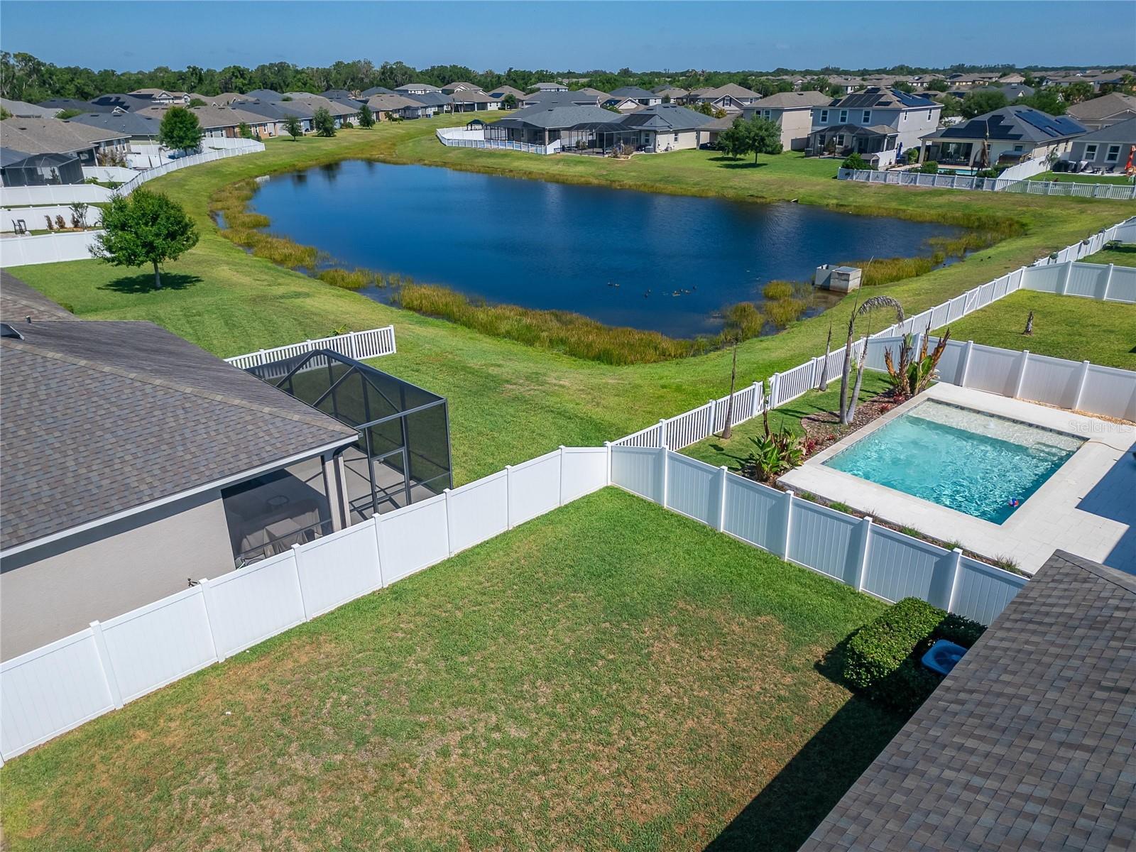 Private fenced backyard with peaceful peek-a-boo pond views..
