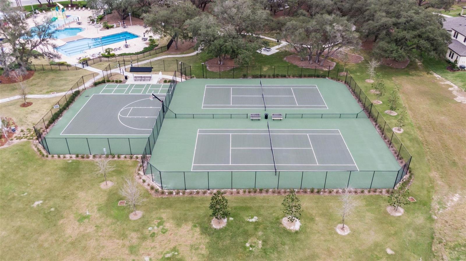 Resort-style amenities include beautifully maintained tennis courts.